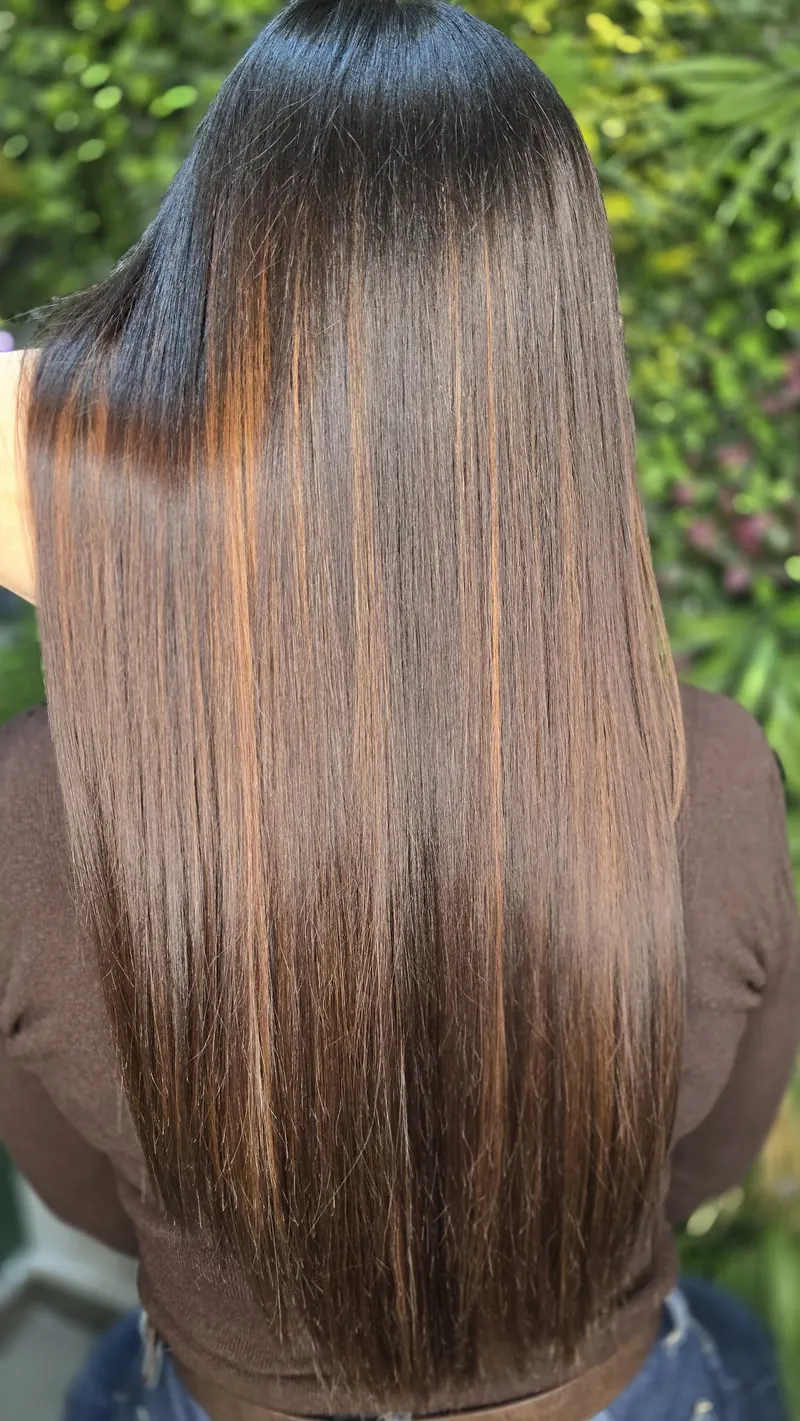 A second view of long, straight chocolate brown hair with copper highlights — hair by Jowita Litwin, Goleniów